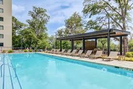 a view of pool with sitting area and garden