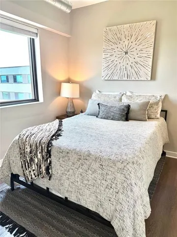 a bedroom with bed and window