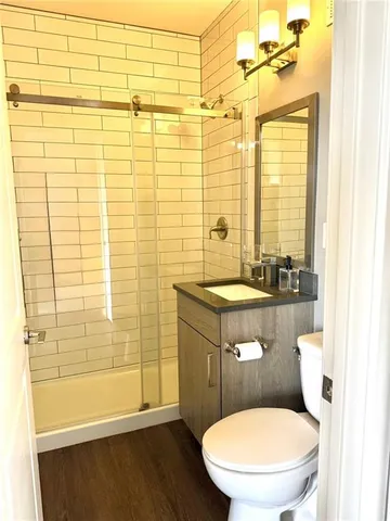 a bathroom with a sink a toilet and shower