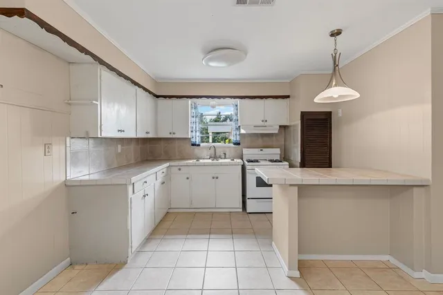 a kitchen with a cabinets and window