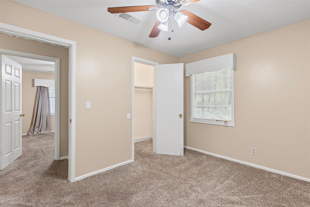 122 Fm 275 Emory, TX 75440 - Photo 21 of 38 an empty room with chandelier fan and windows