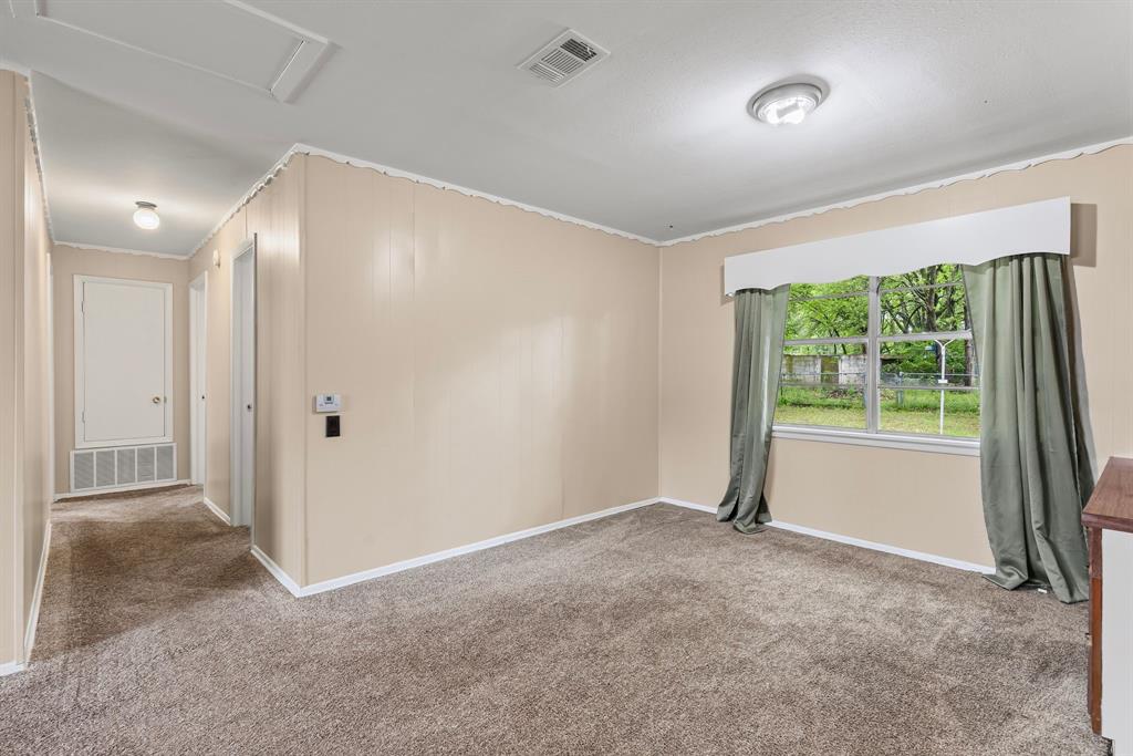 122 Fm 275 Emory, TX 75440 - Photo 8 of 38 an empty room with large windows and a ceiling fan