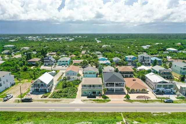 an aerial view of residential houses with yard