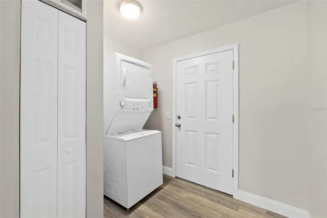 a view of a hallway with wooden floor and entryway