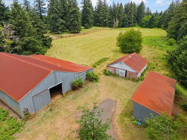 an aerial view of a house with a garden and lake view