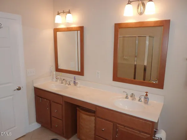 a bathroom with a double vanity sink and a mirror