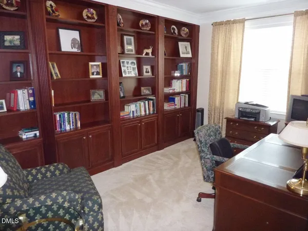 a bedroom with a bed and a bookshelf