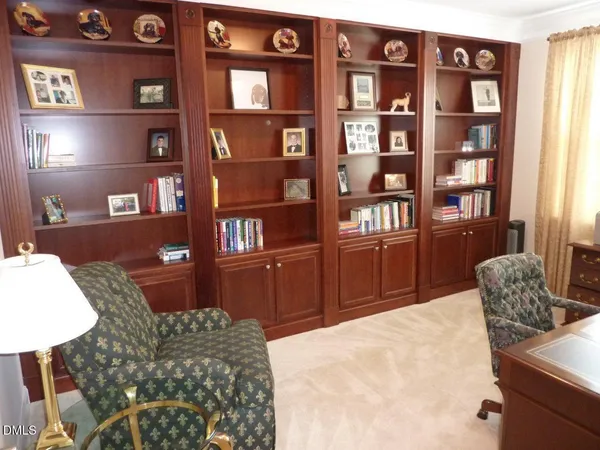 a living room with furniture cabinets and book shelf
