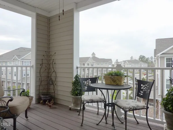 a view of a balcony with chair and wooden floor