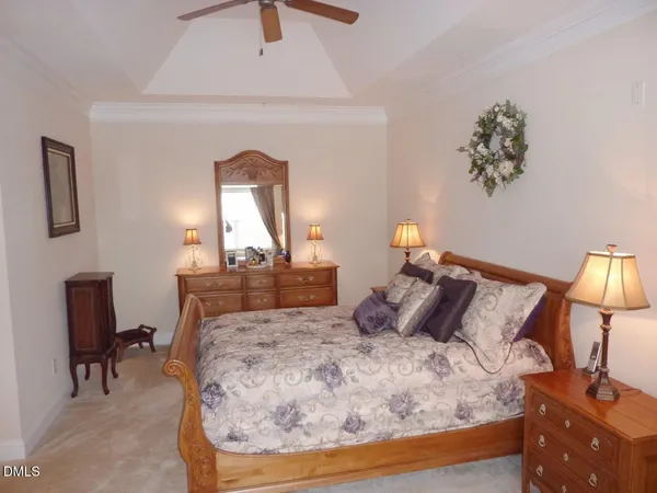 a bedroom with a bed and a lamp on table