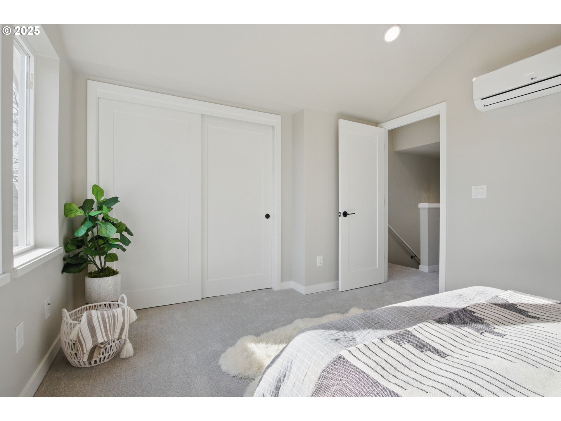 1123 Southeast Rhone Street, Unit B Portland, OR 97202 - Photo 15 of 22 a bedroom with a bed and a potted plant