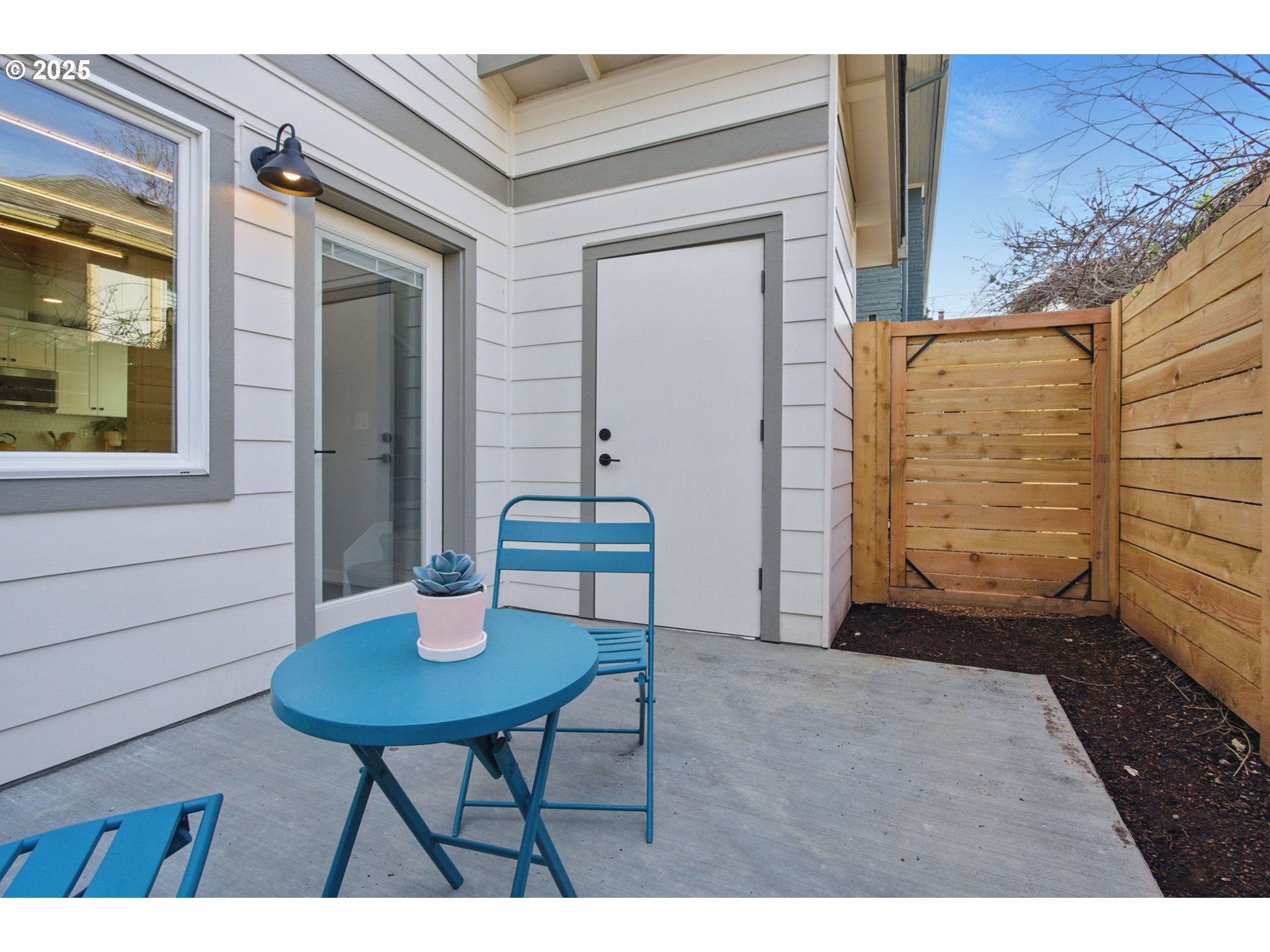 1123 Southeast Rhone Street, Unit B Portland, OR 97202 - Photo 20 of 22 a balcony with table and chairs