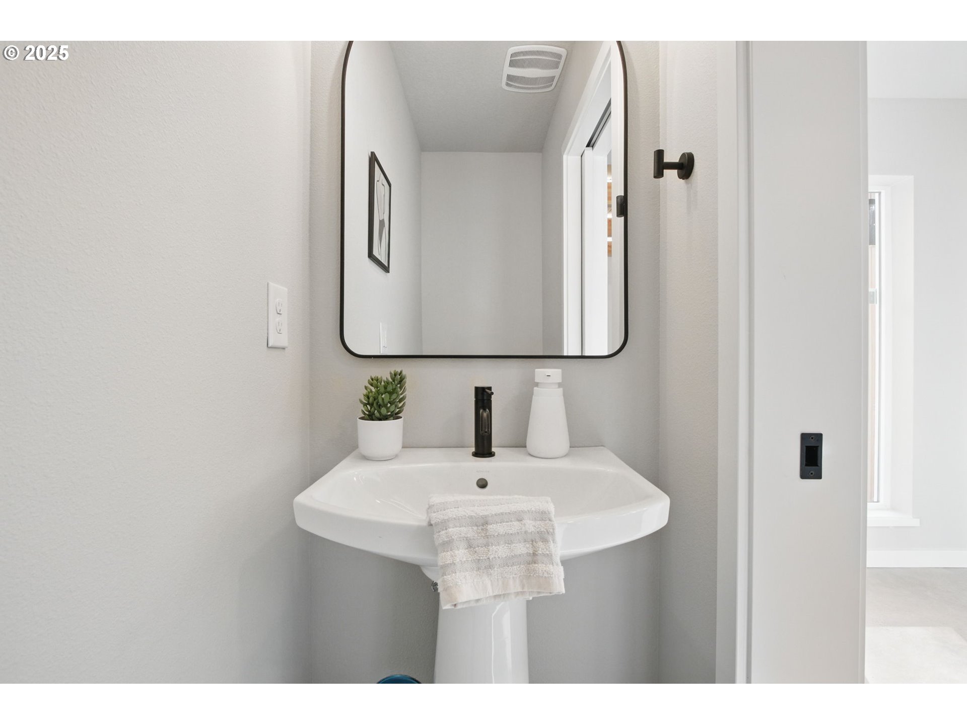 1123 Southeast Rhone Street, Unit B Portland, OR 97202 - Photo 9 of 22 a bathroom with a sink and a mirror