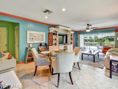 8693 Querce Court Naples, FL 34114 - Photo 11 of 50 a living room with furniture and a large window