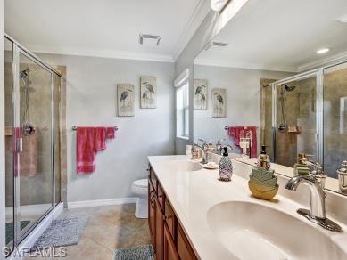 8693 Querce Court Naples, FL 34114 - Photo 15 of 50 a bathroom with a double vanity sink mirror and shower