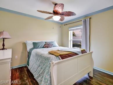 8693 Querce Court Naples, FL 34114 - Photo 16 of 50 a bedroom with a bed and a chandelier