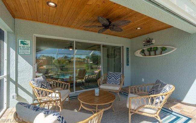 8693 Querce Court Naples, FL 34114 - Photo 21 of 50 a dining room with furniture and a floor to ceiling window