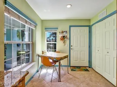 a view of a dining room with furniture and window