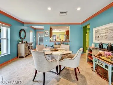 a dining room with furniture and a large window