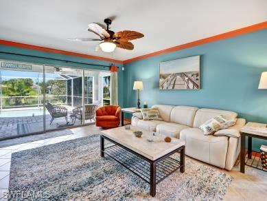 8693 Querce Court Naples, FL 34114 - Photo 10 of 50 a living room with furniture a table and a large window