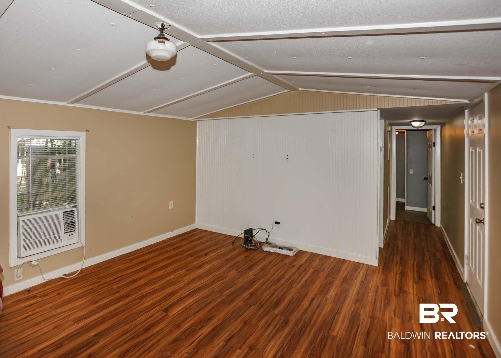 11998 Workman Avenue Foley, AL 36535 - Photo 42 of 59 Spare room with wood finished floors and vaulted ceiling