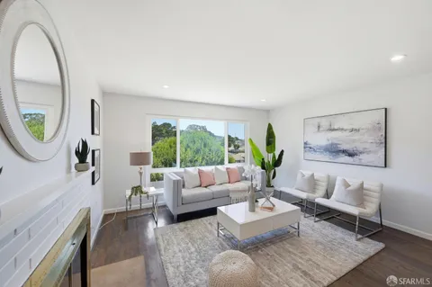 a living room with furniture a window and a fireplace