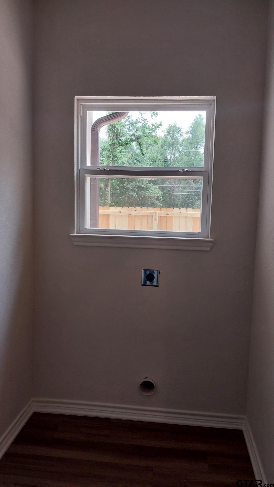 1262 George Richey Road Gladewater, TX 75647 - Photo 18 of 22 a view of a small space with wooden floor and a window