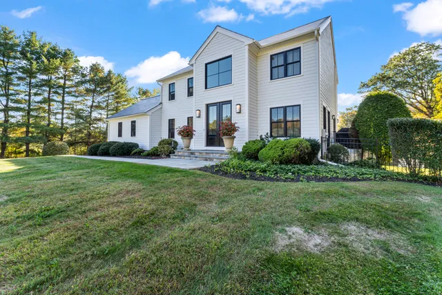 a view of backyard of house with green space