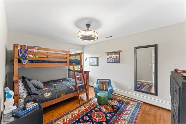 a bathroom with a sink toilet and a mirror