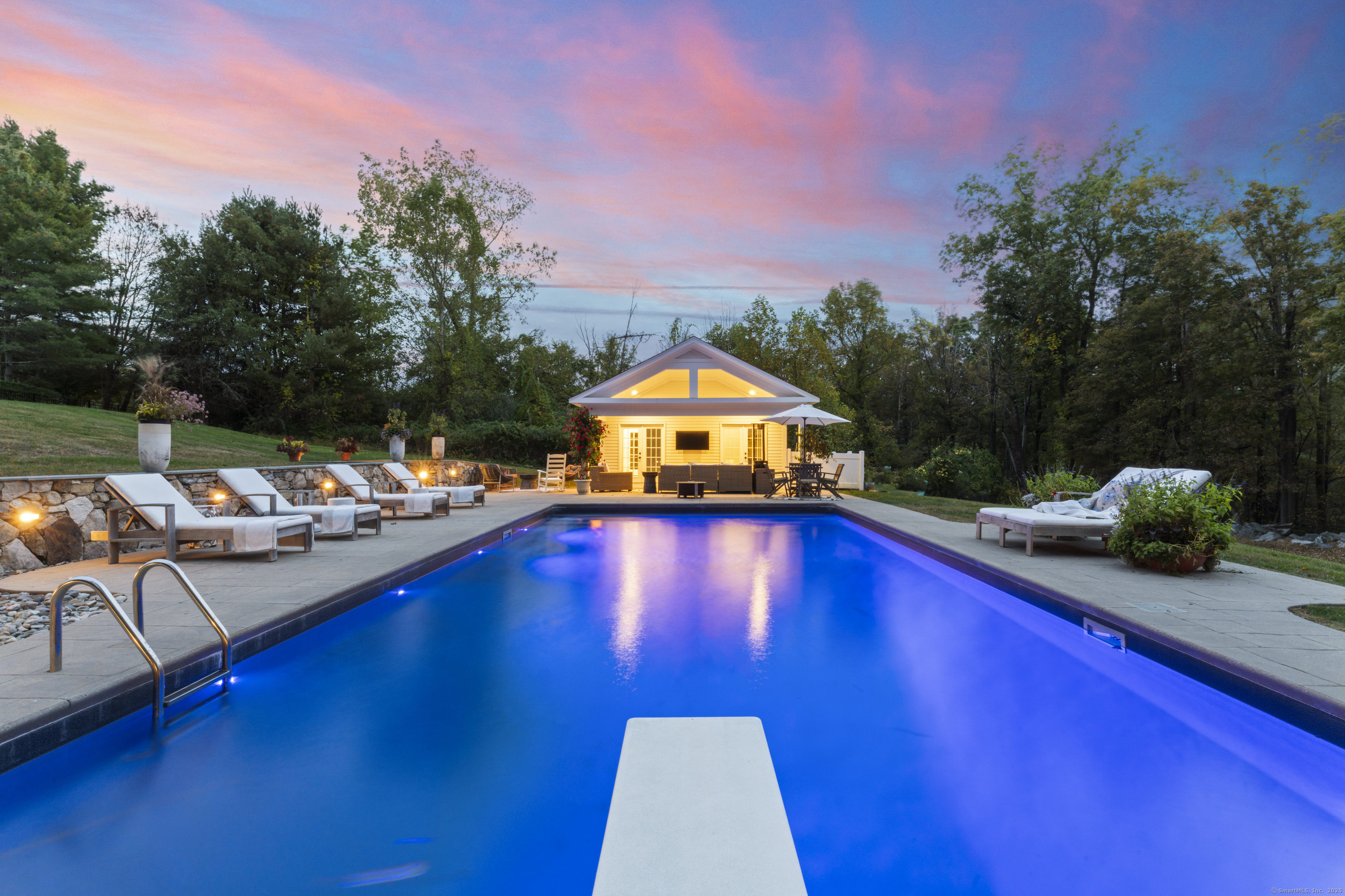 40 Great Ring Road Newtown, CT 06482 - Photo 35 of 39 a view of swimming pool with seating area and trees in the background