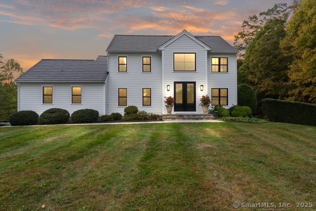 40 Great Ring Road Newtown, CT 06482 - Photo 36 of 39 a front view of house with yard and green space