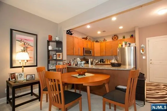 a dining table with chairs and window