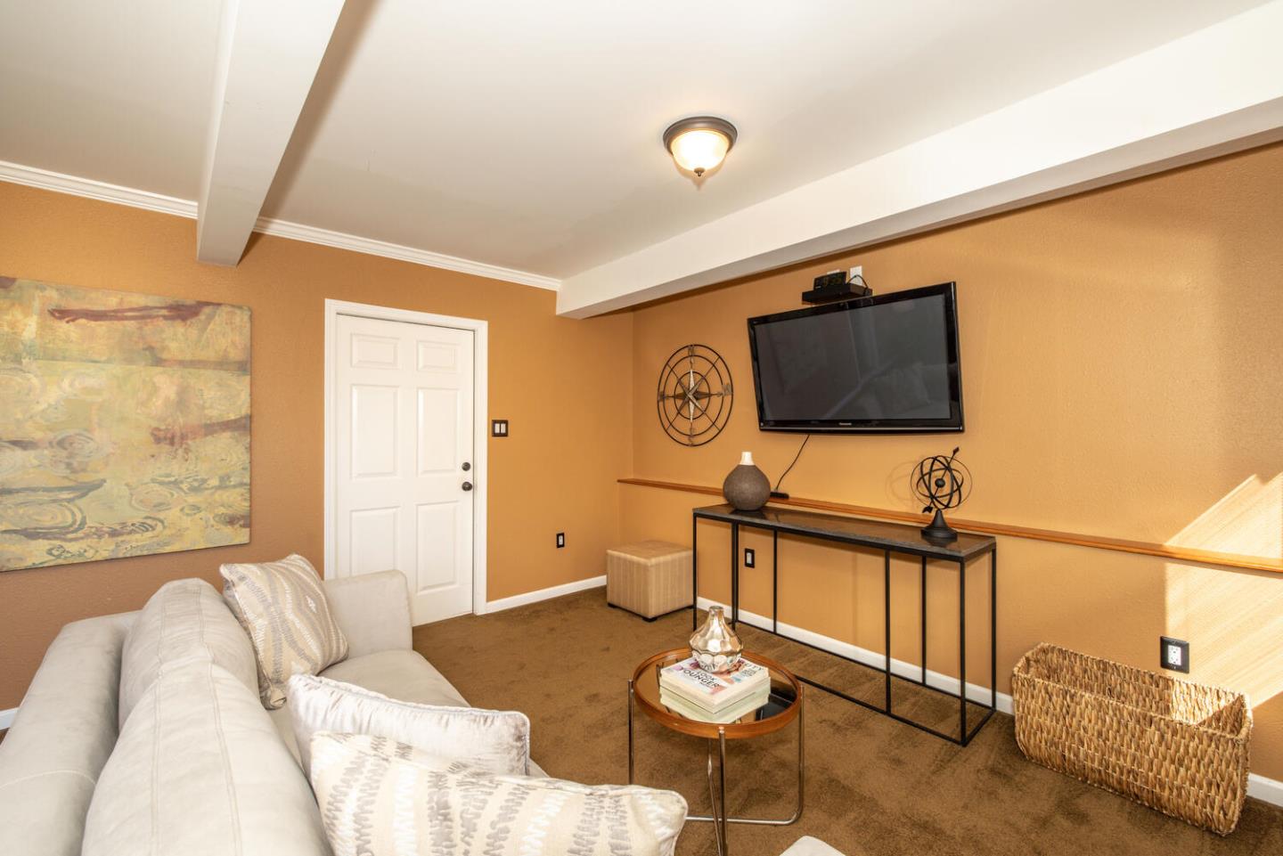 1420 Crespi Drive Pacifica, CA 94044 - Photo 17 of 48 a living room with furniture and a flat screen tv