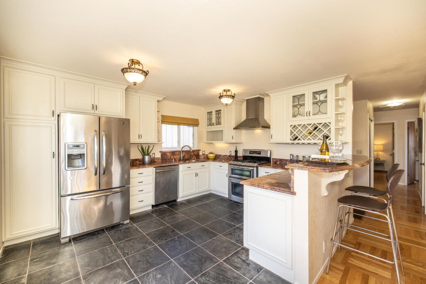 1420 Crespi Drive Pacifica, CA 94044 - Photo 27 of 48 a kitchen with cabinets and stainless steel appliances