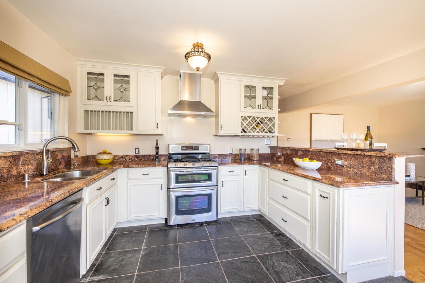 1420 Crespi Drive Pacifica, CA 94044 - Photo 28 of 48 a kitchen with a sink stove and cabinets
