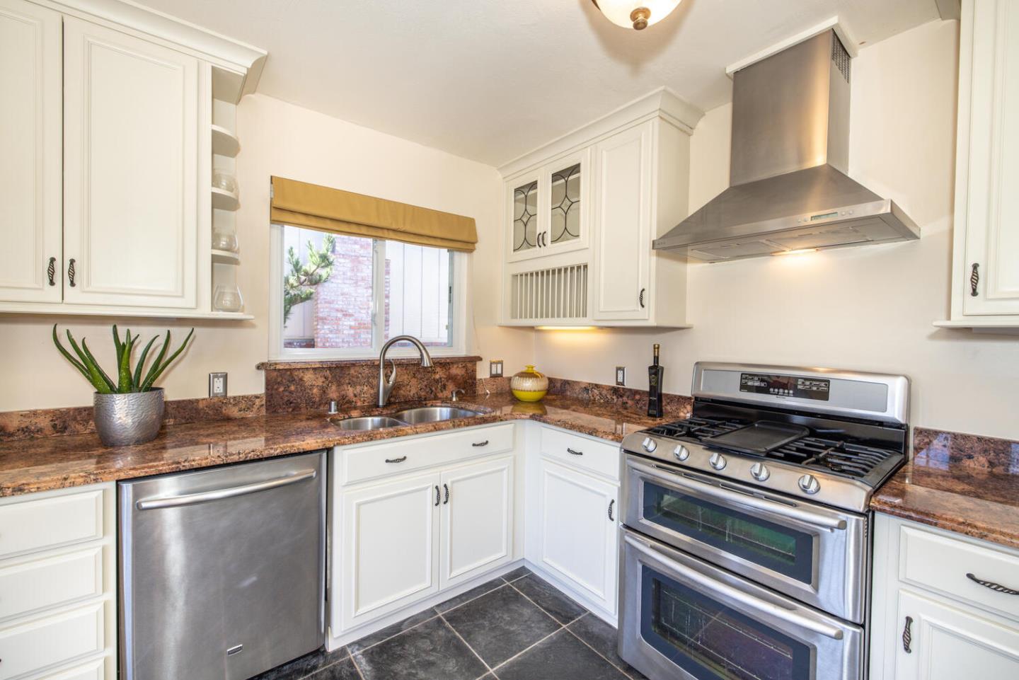 1420 Crespi Drive Pacifica, CA 94044 - Photo 29 of 48 a kitchen with stainless steel appliances granite countertop a sink a stove and a granite counter tops