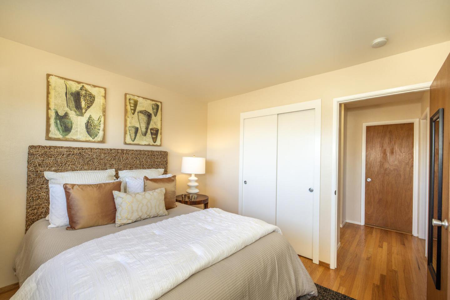 1420 Crespi Drive Pacifica, CA 94044 - Photo 7 of 48 a bedroom with a bed and a painting on the wall