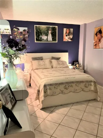 a bedroom with a bed and dresser