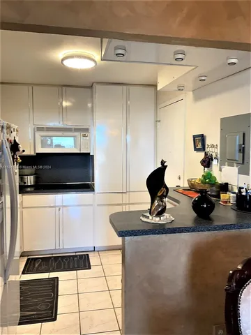 a living room with a couch and a stove top oven
