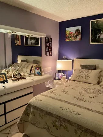 a bedroom with a bed and painting on the wall