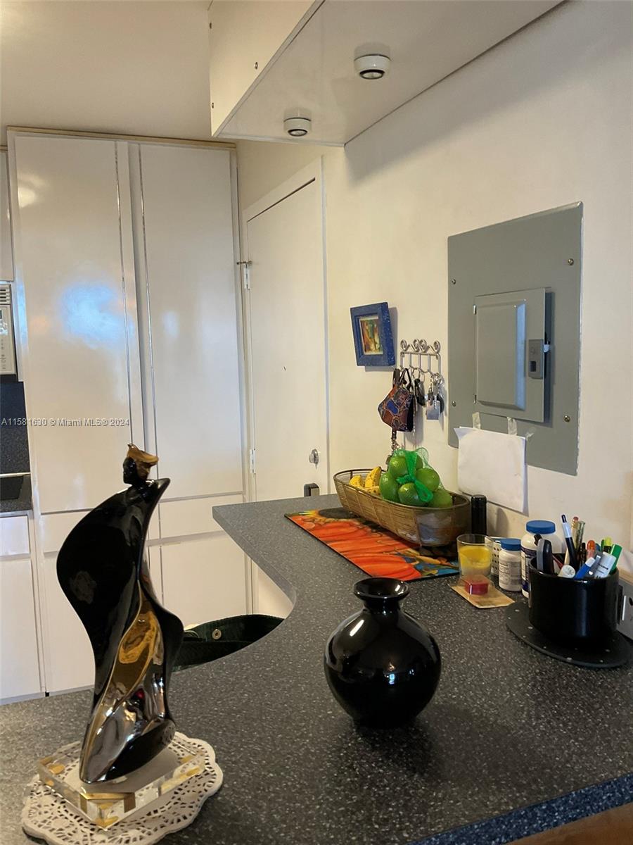 4675 West 18th Court, Unit 502 Hialeah, FL 33012 - Photo 9 of 13 a living room with furniture and a table