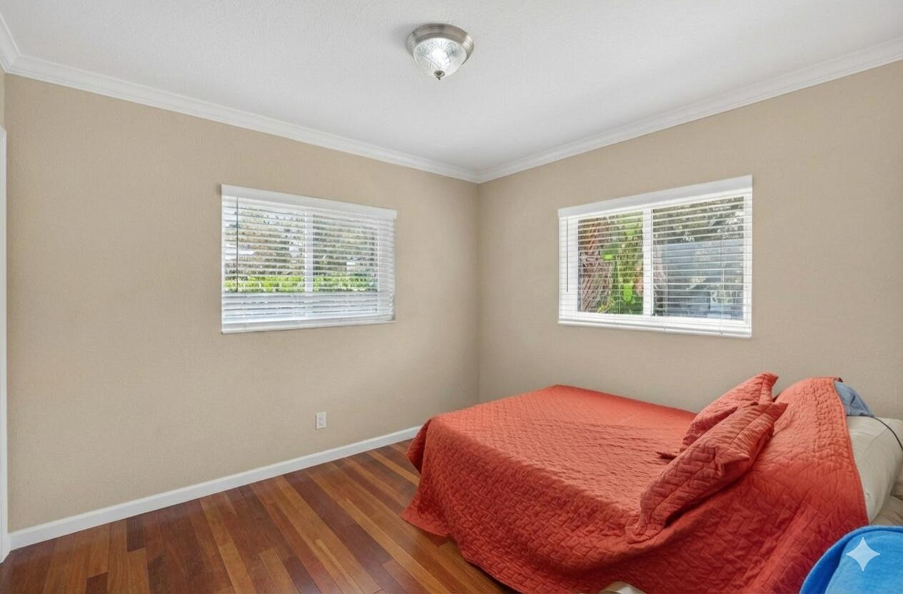 6091 Southwest 12th Street West Miami, FL 33144 - Photo 21 of 38 a bedroom with a bed and a window