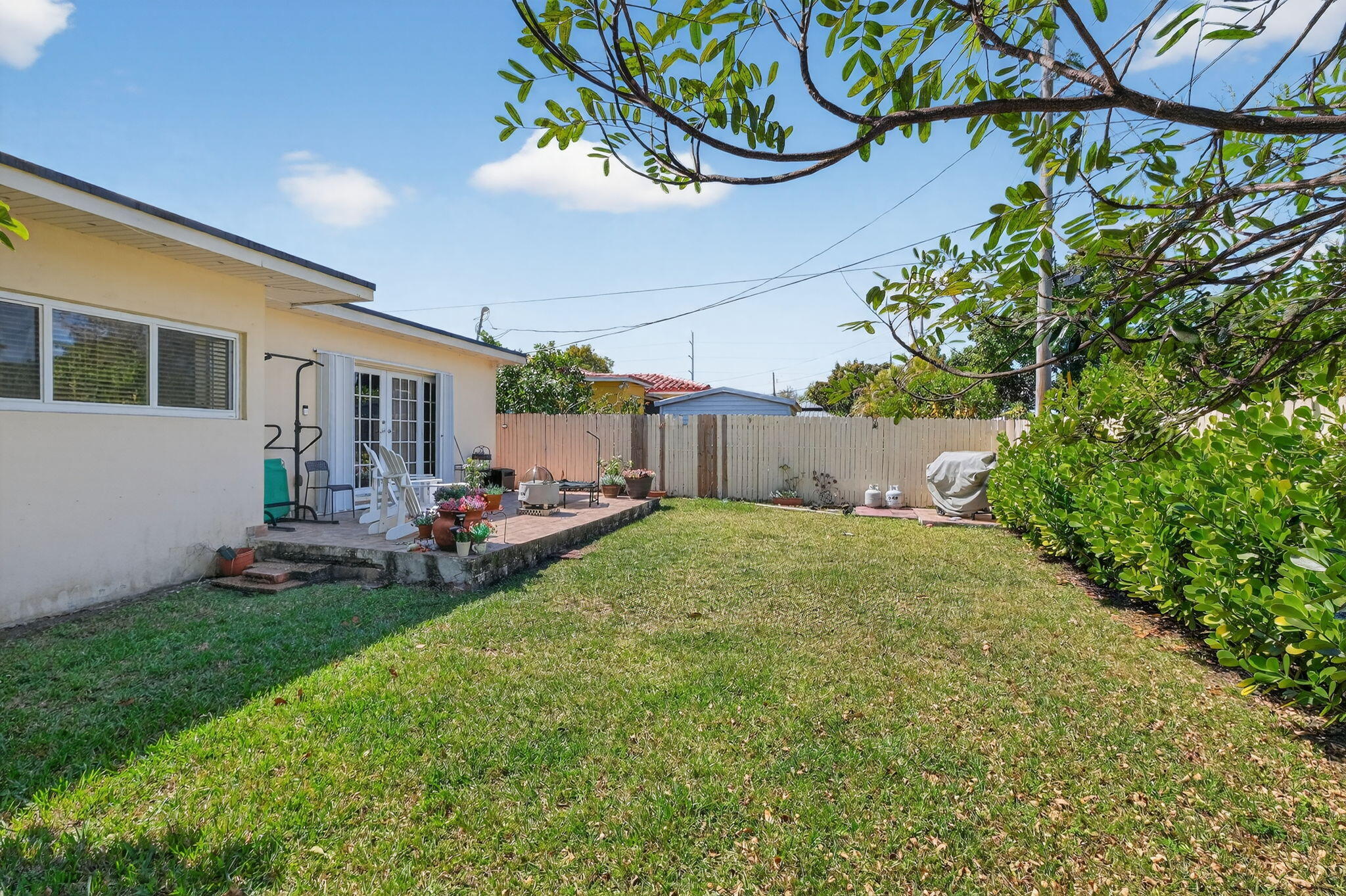 6091 Southwest 12th Street West Miami, FL 33144 - Photo 30 of 38 a view of a backyard with plants and a garden