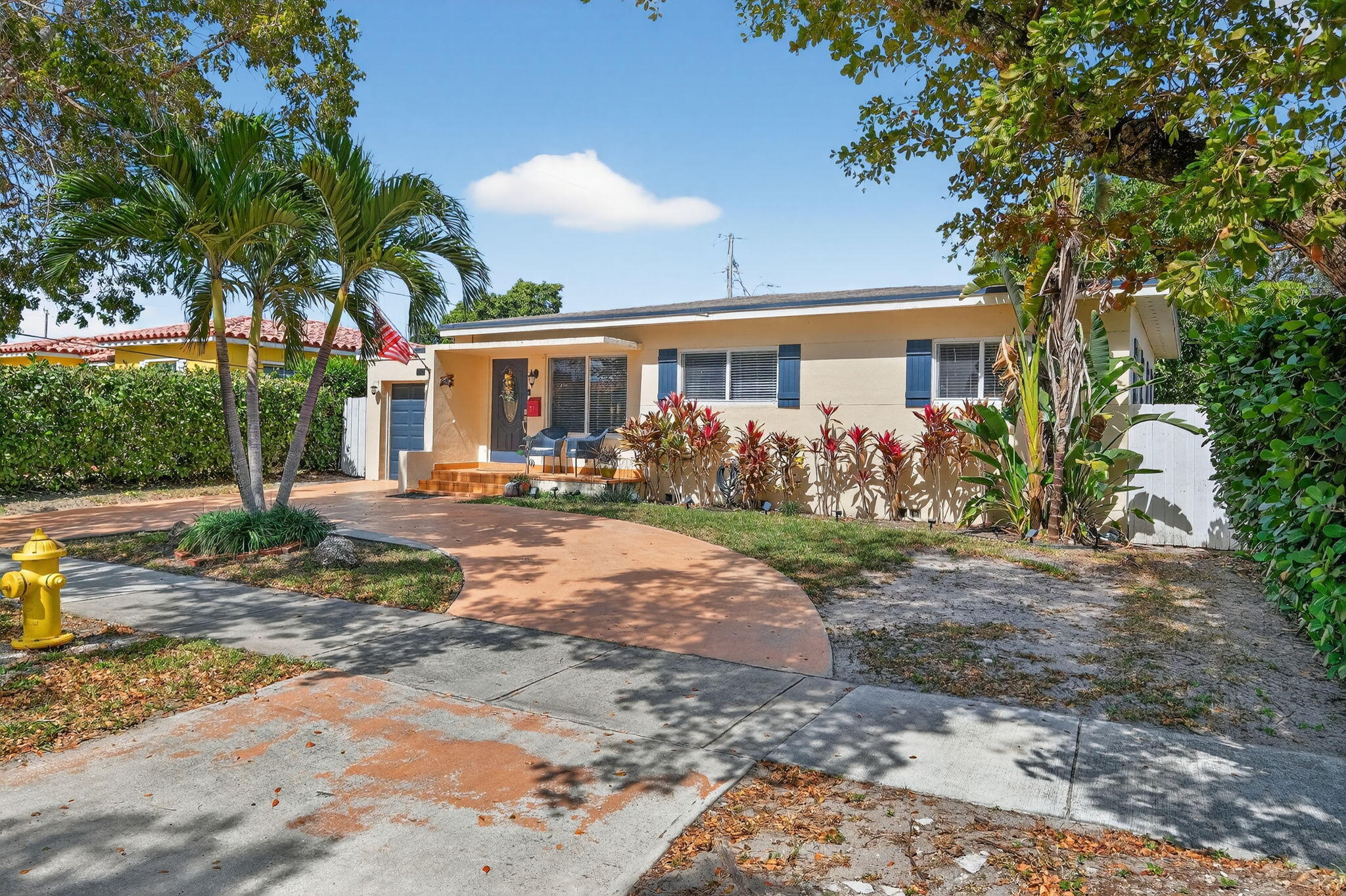 6091 Southwest 12th Street West Miami, FL 33144 - Photo 32 of 38 a front view of a house with garden