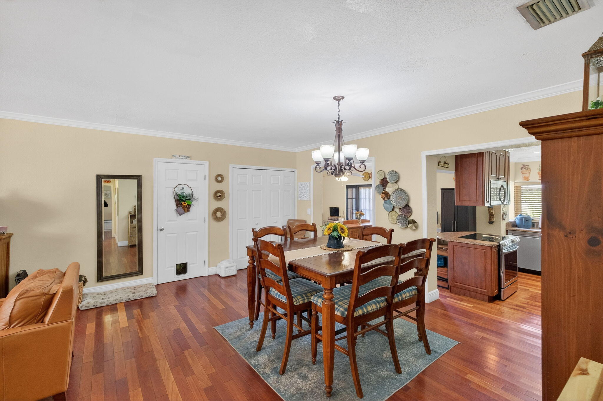 6091 Southwest 12th Street West Miami, FL 33144 - Photo 7 of 38 a view of a dining room with furniture wooden floor and chandelier