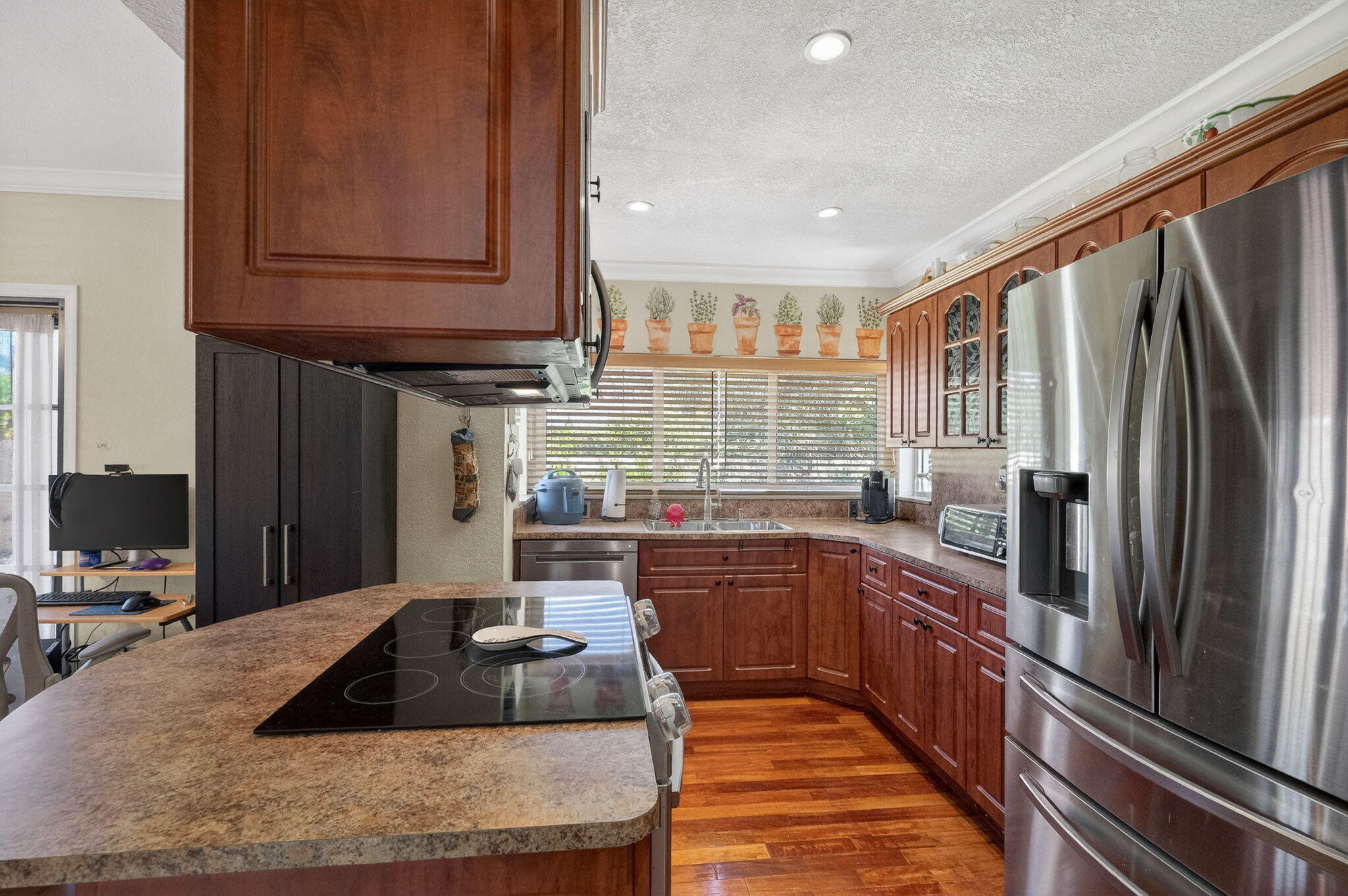 6091 Southwest 12th Street West Miami, FL 33144 - Photo 9 of 38 a kitchen with stainless steel appliances granite countertop a sink dishwasher stove and refrigerator with wooden floor
