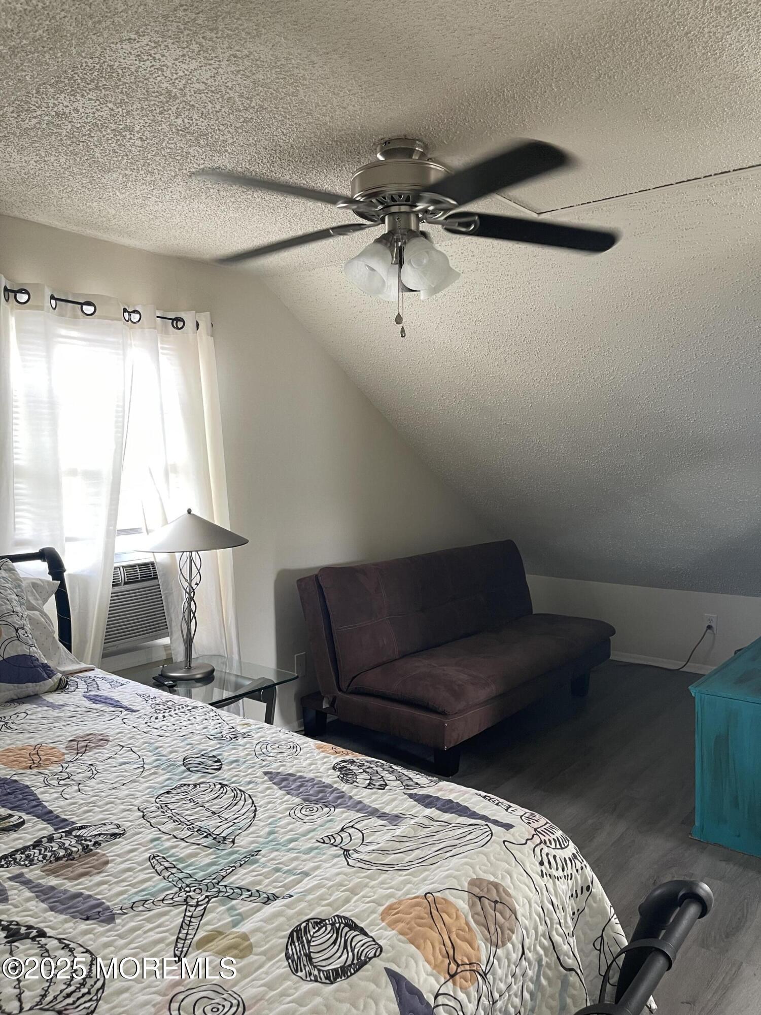 202 Carteret Avenue, Unit B5 Seaside Heights, NJ 08751 - Photo 12 of 17 a bedroom with a bed and wooden floor