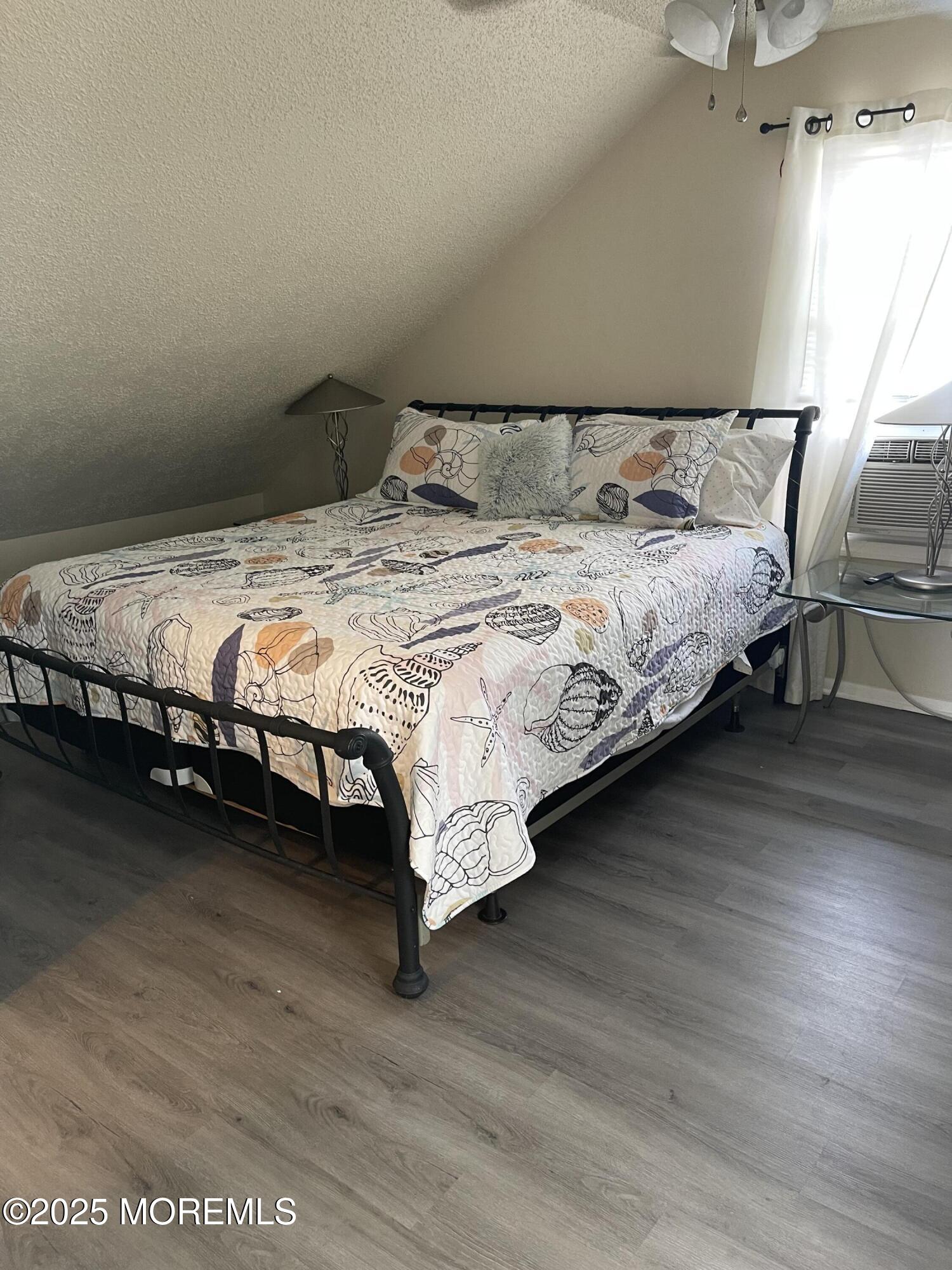 202 Carteret Avenue, Unit B5 Seaside Heights, NJ 08751 - Photo 13 of 17 a bedroom with a bed wooden floor and window