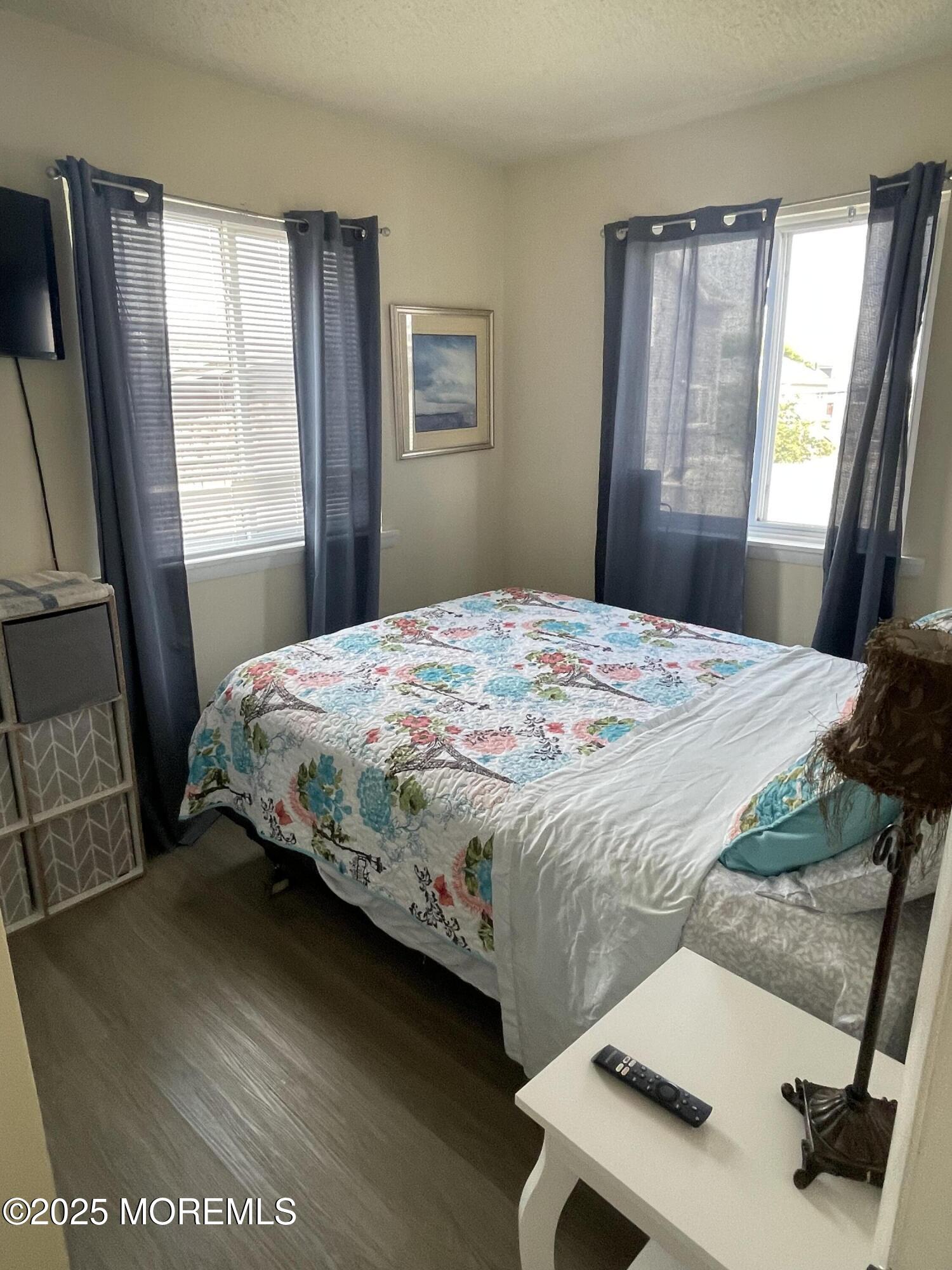 202 Carteret Avenue, Unit B5 Seaside Heights, NJ 08751 - Photo 5 of 17 a bedroom with a bed window and a dresser