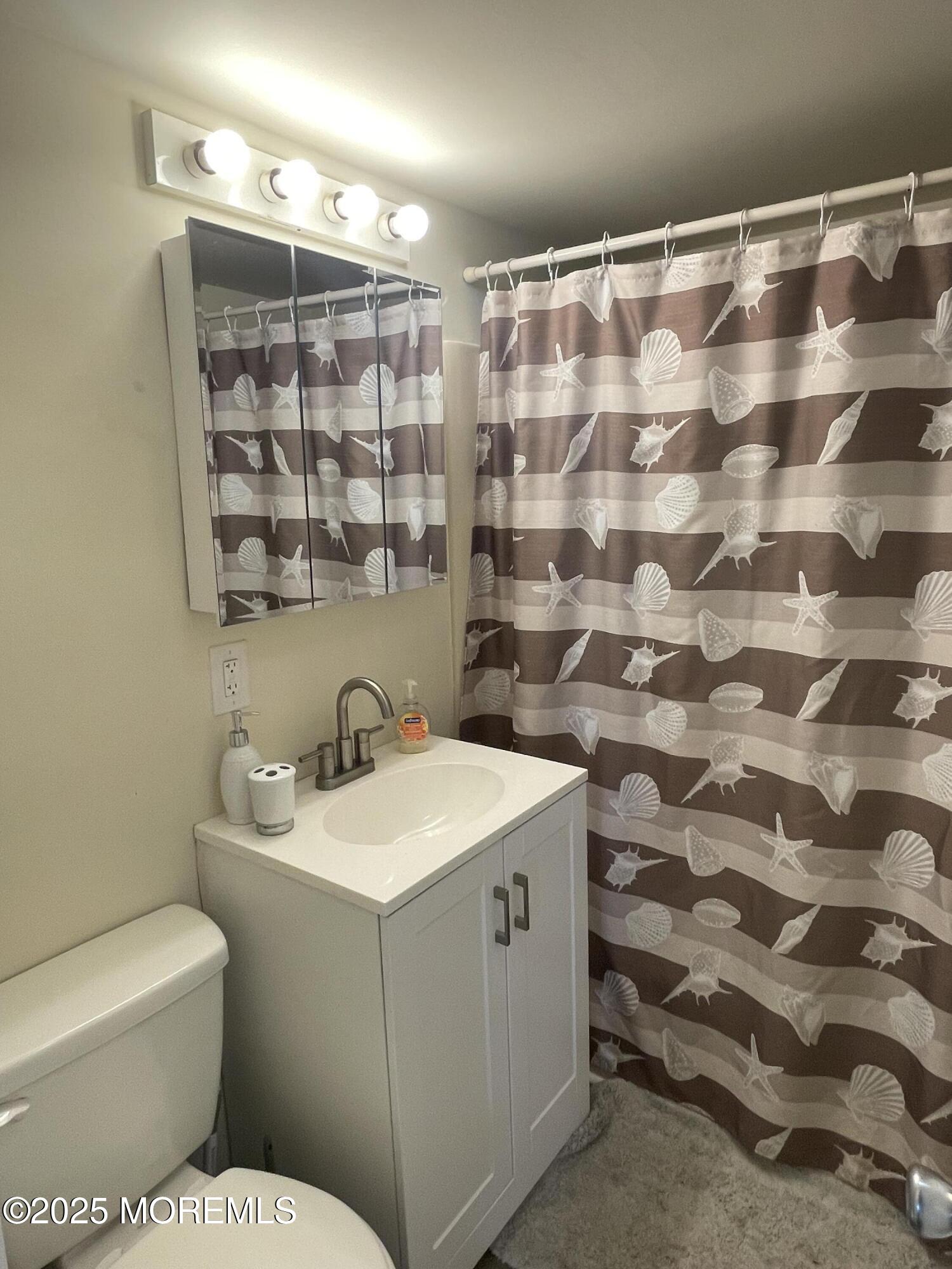 202 Carteret Avenue, Unit B5 Seaside Heights, NJ 08751 - Photo 6 of 17 a bathroom with a sink and a mirror